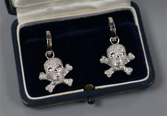 A modern pair of 18ct white gold and diamond encrusted skull and crossbones earrings, in Theo Fennell box, 20mm.